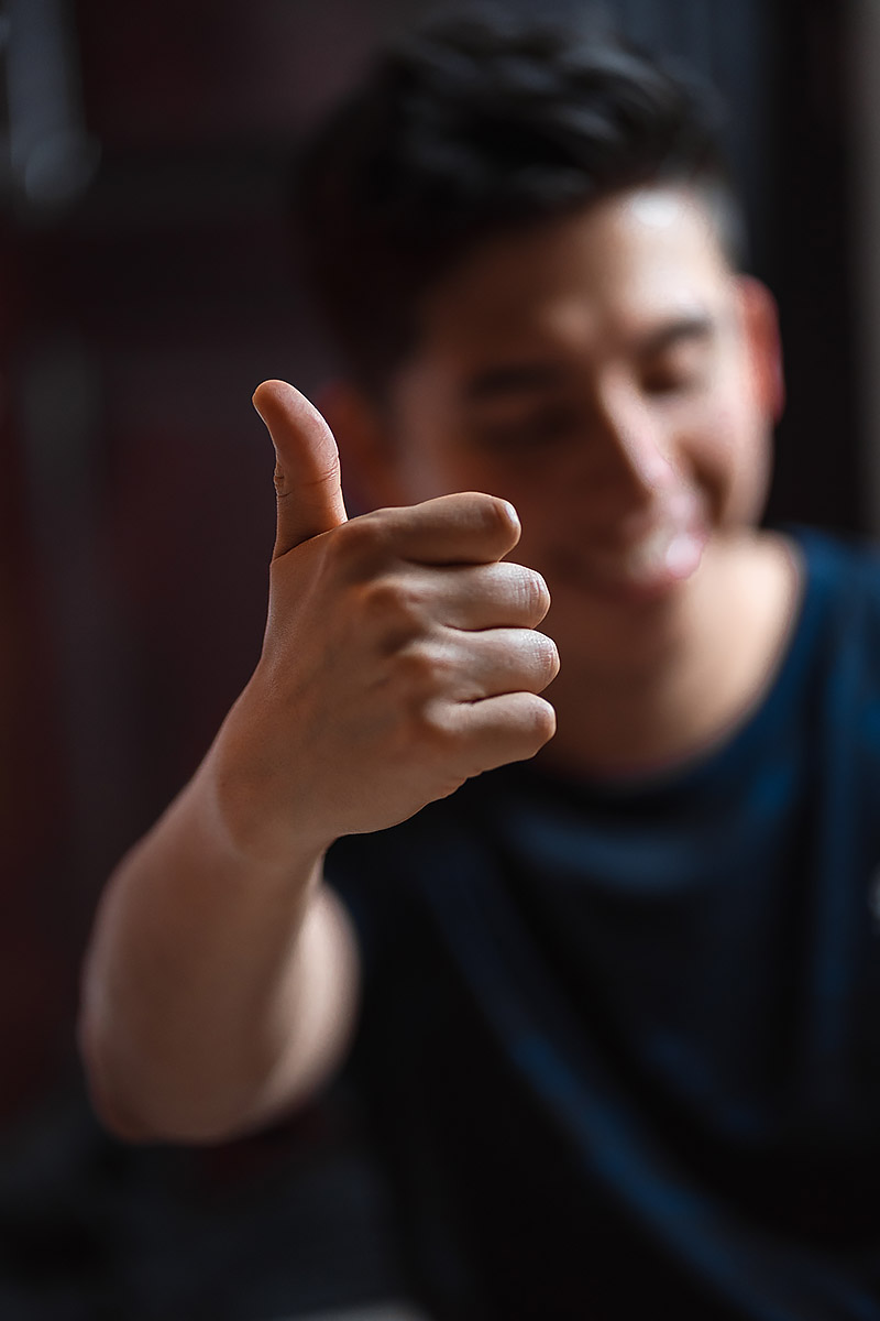 Smiling young man with thumb up